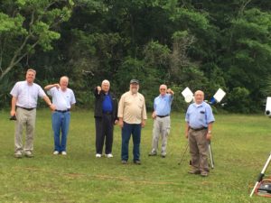 Club members indicating their displeasure with the beautiful sunrise as the transit begins.